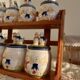 Vintage wooden wall condiment shelf and porcelain pots with geese slip pattern