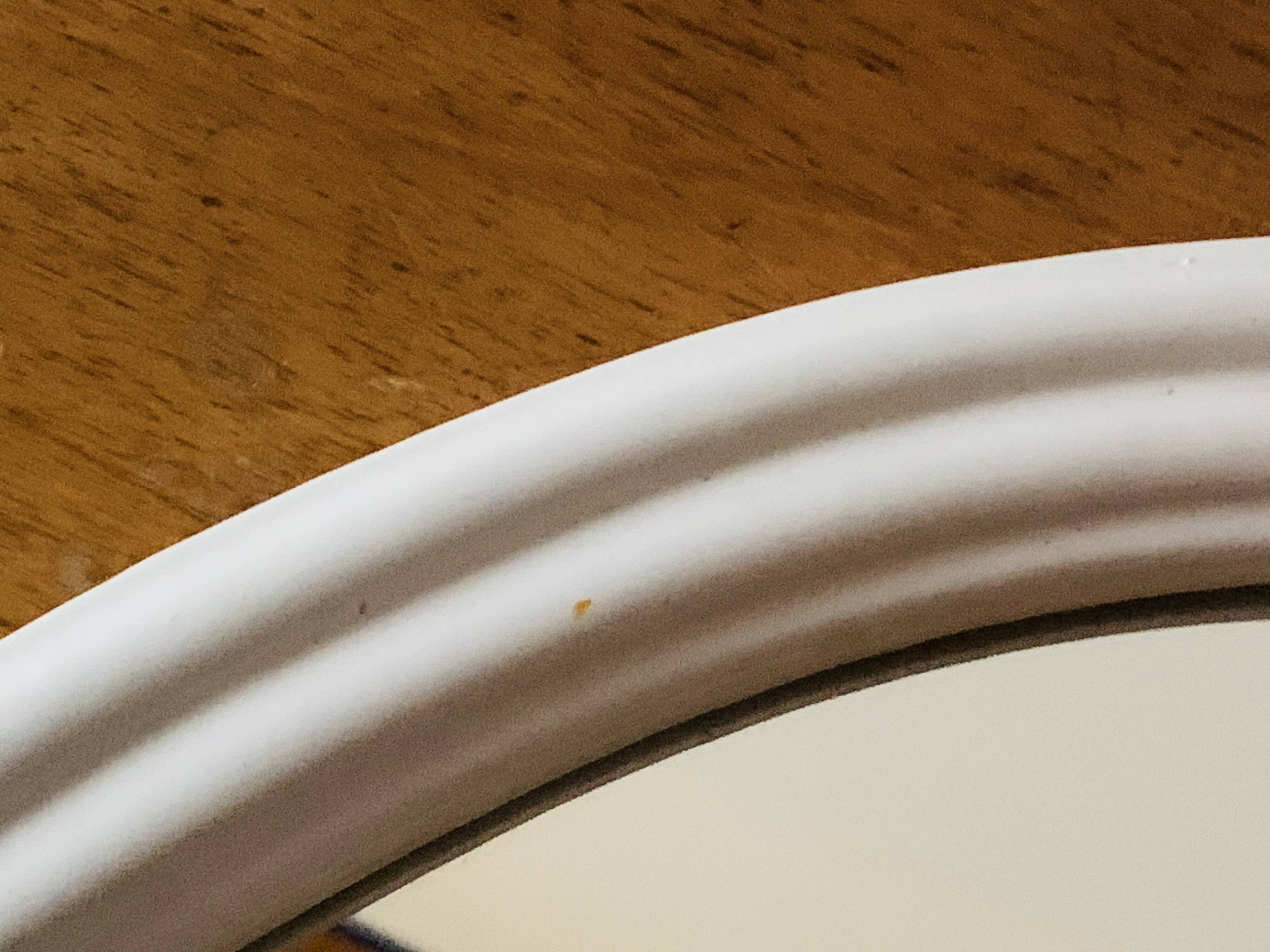 Oval mirror in vintage enameled white cast iron