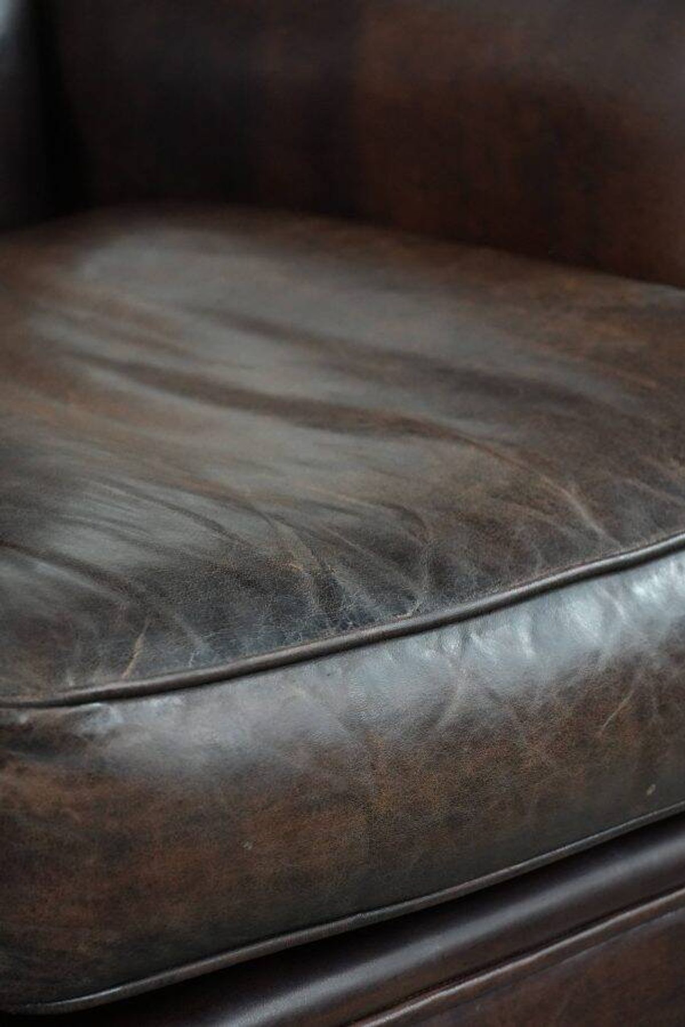 Characterful sheep leather armchair with a beautiful deep colour