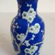 Old blue vase with vintage porcelain cherry blossoms