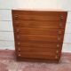 Brown teak Mid-Century chest of drawers with 7 drawers from the 1960s, sleek lines, discreet base.