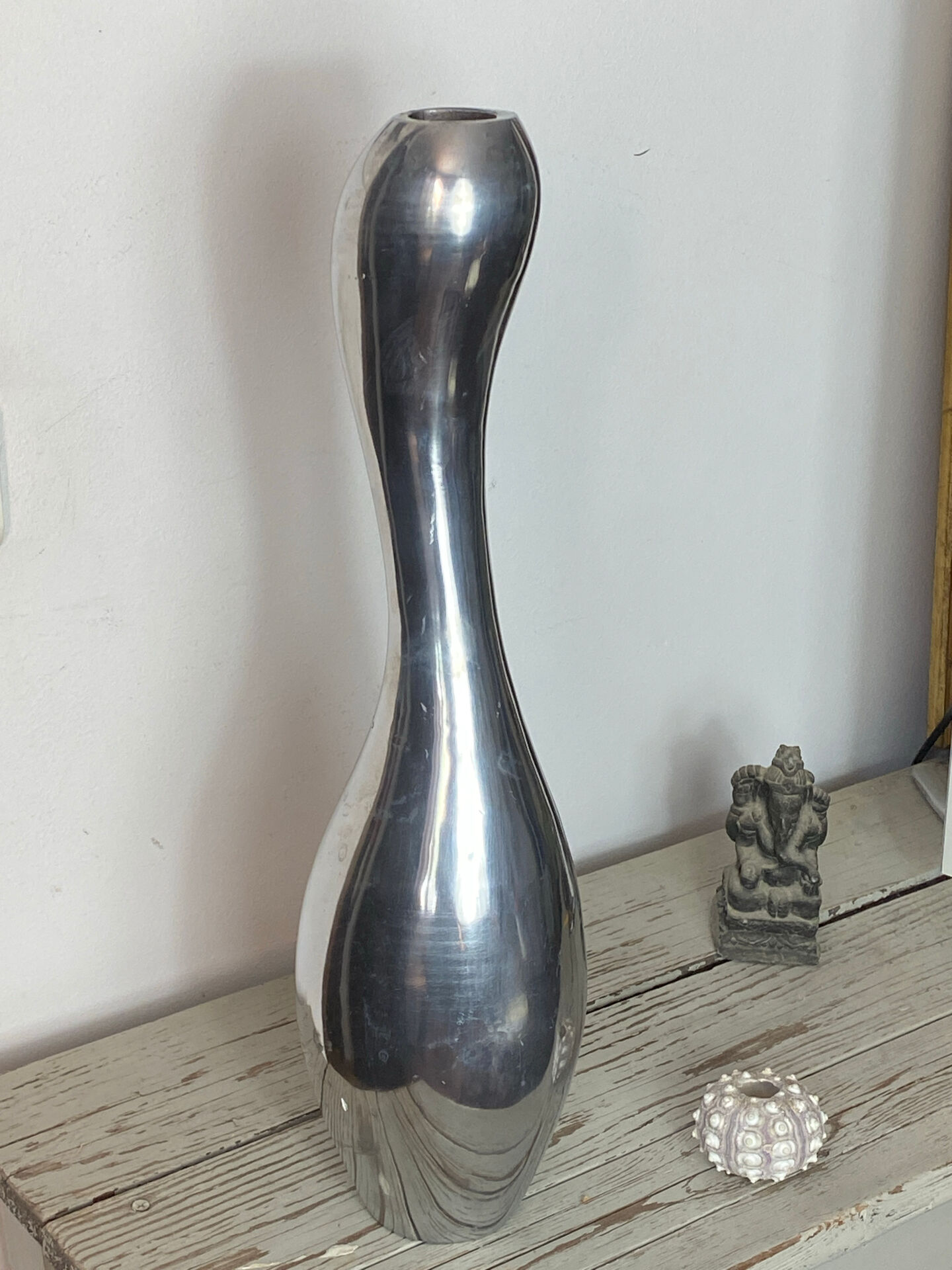 Large organic vase in polished aluminium cast.