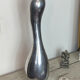 Large organic vase in polished aluminium cast.