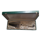 Silver metal cake peeler.