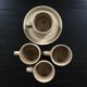 Set of 4 beige stoneware mugs.