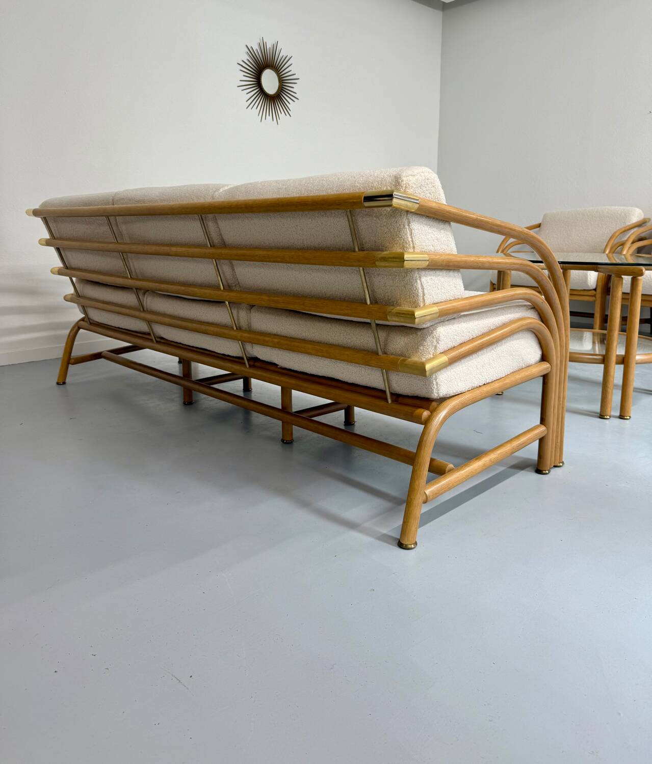 Complete living room with rattan sofa and white bouclette, brass finish, 80's design