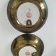 A pair of vintage Chinese decorative plates with floral designs on a yellow background.