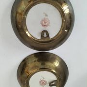 A pair of vintage Chinese decorative plates with floral designs on a yellow background.