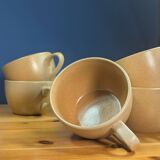 Jug and 5 cups in orange stoneware, very good condition, signed and numbered