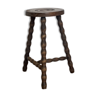 Antique tripod stool made of twisted wood