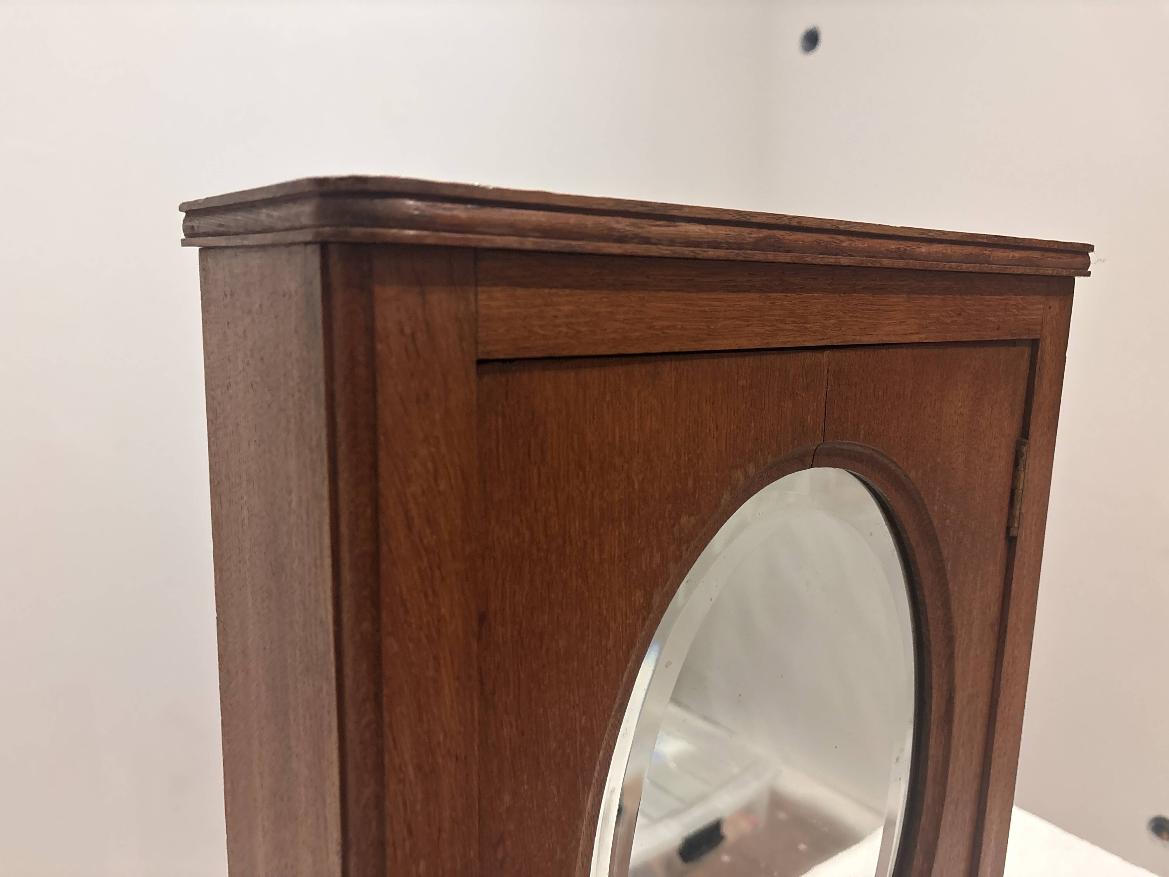 Wall cabinet with oval wall and drawer
