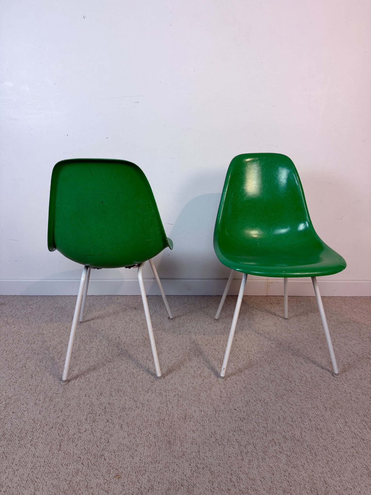 Eames Herman Miller chairs in green fiberglass.