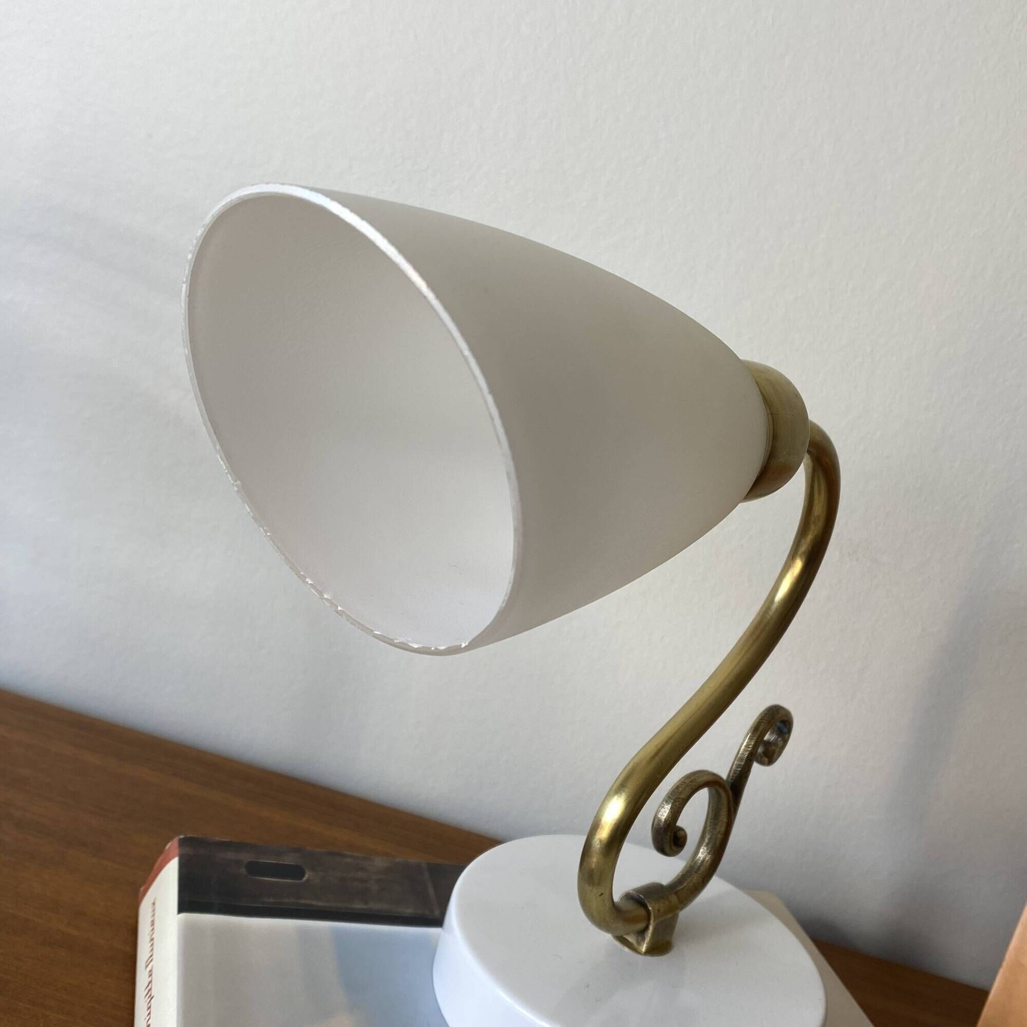 Pair of brass swan neck wall lights with white glass shades.