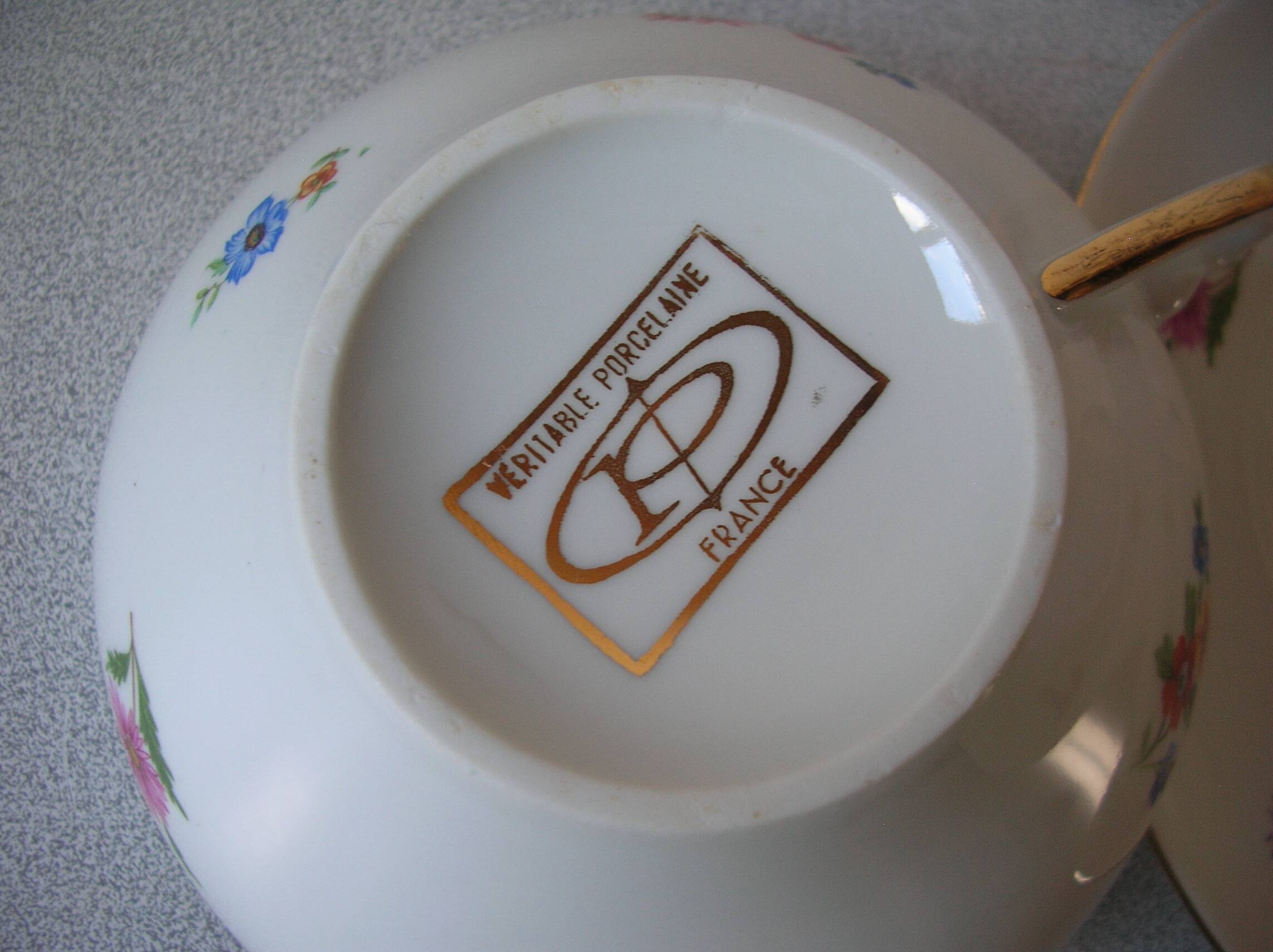 Old large tea cup and saucer in Limoges porcelain with flower decor