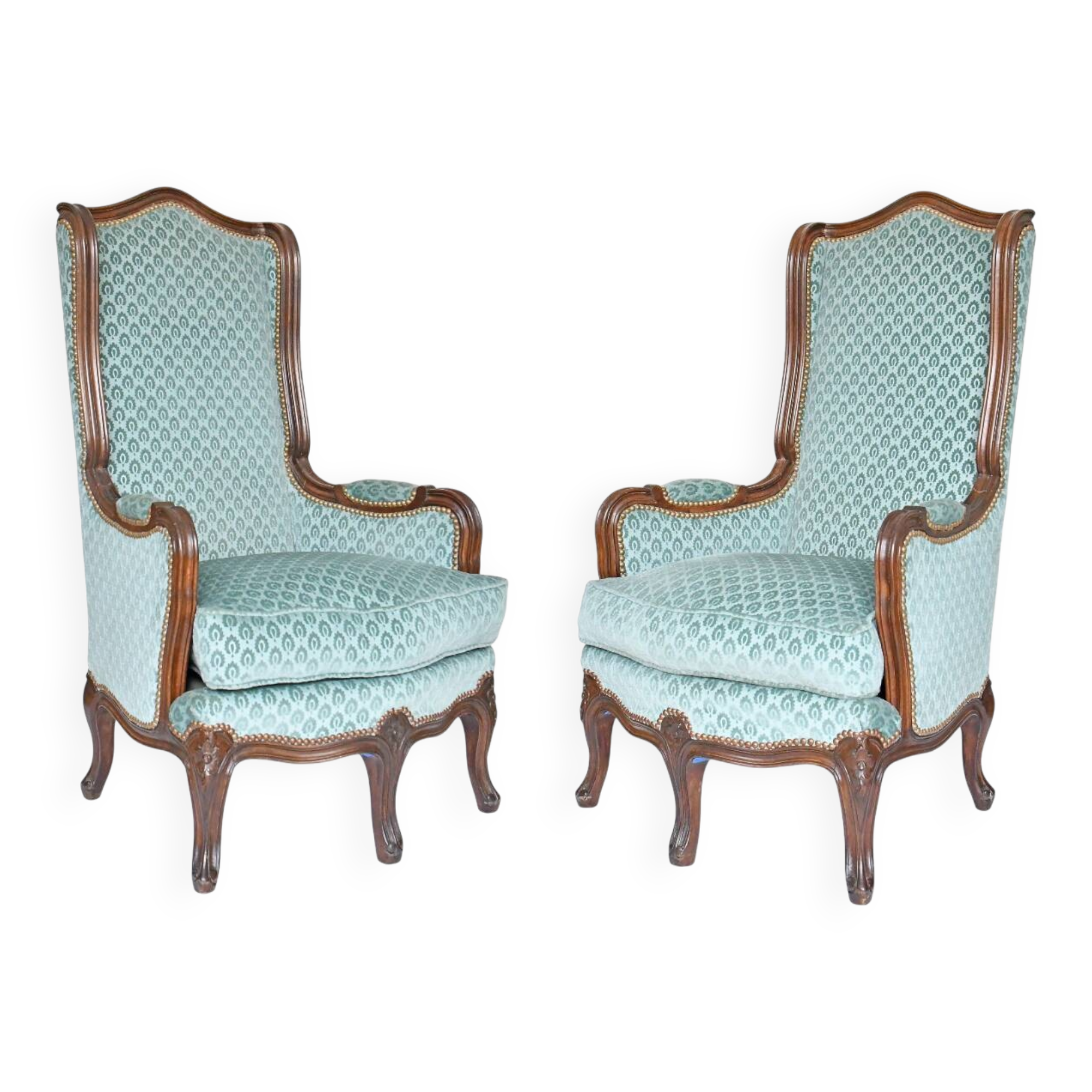 Pair of Louis XV style wingback armchairs with five legs.