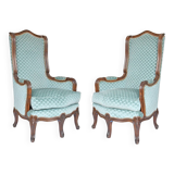 Pair of Louis XV style wingback armchairs with five legs.