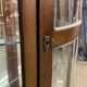 Wooden display case and half-moon mirror