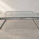 Coffee table in chrome with a glass top.