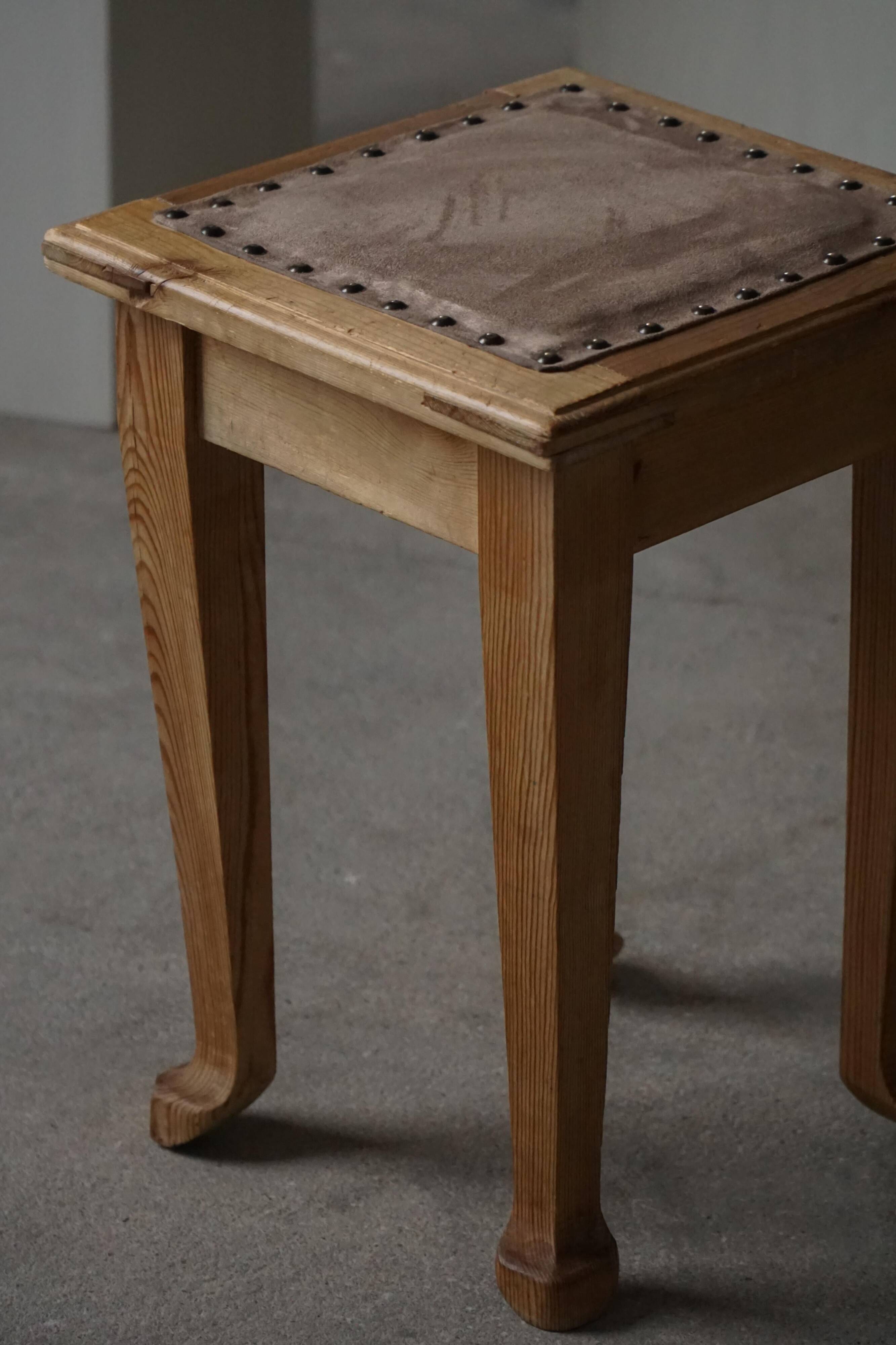 A pair of antique Danish pine stools from the late 19th century.
