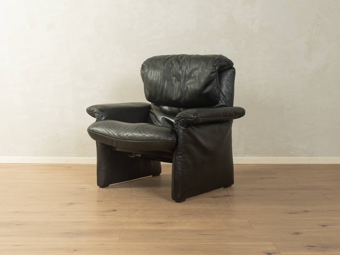 1980s cor armchair and ottoman in black leather