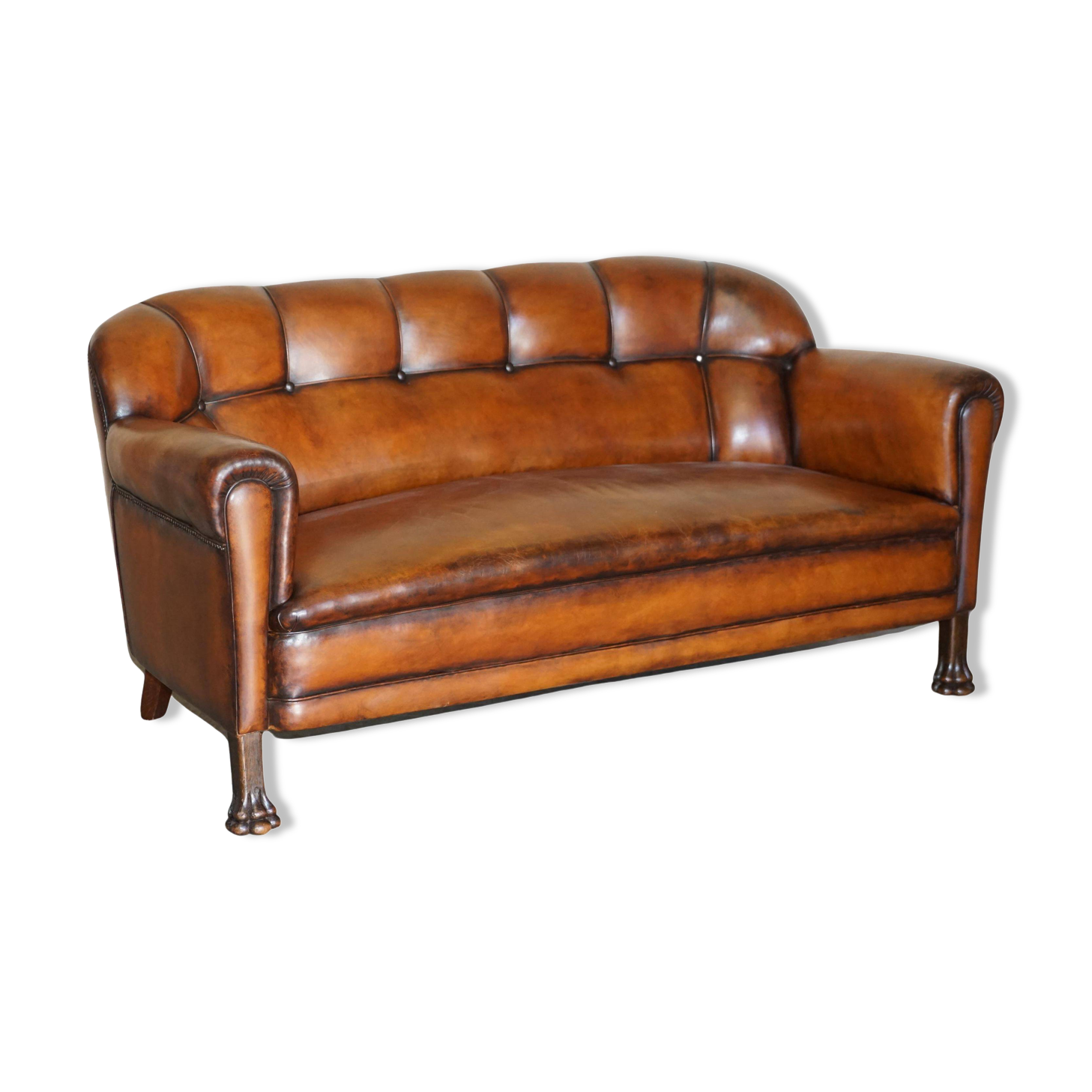 Victorian Chesterfield leather canapé with oak lion claw feet.