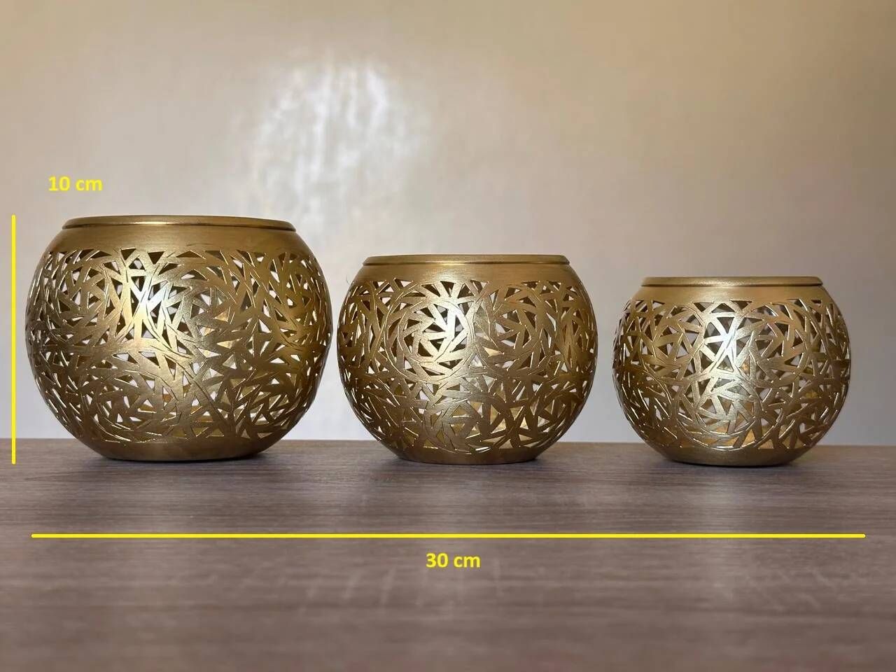 Set of 3 handmade brass candle holders with an openwork pattern.