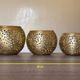 Set of 3 handmade brass candle holders with an openwork pattern.