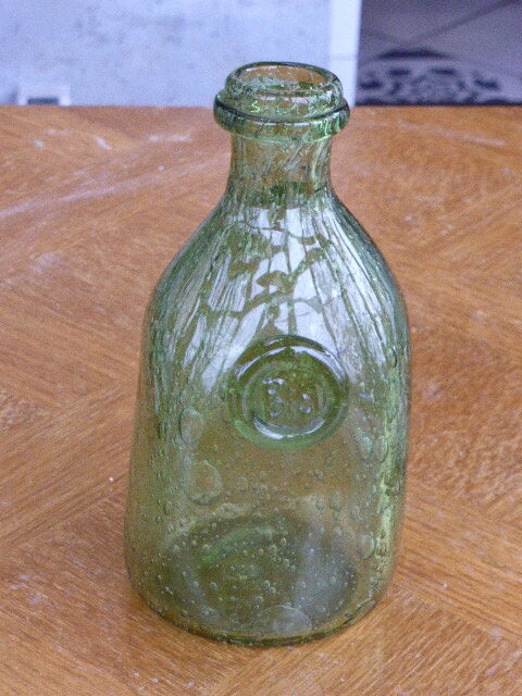 Biot stamped blown glass bottle