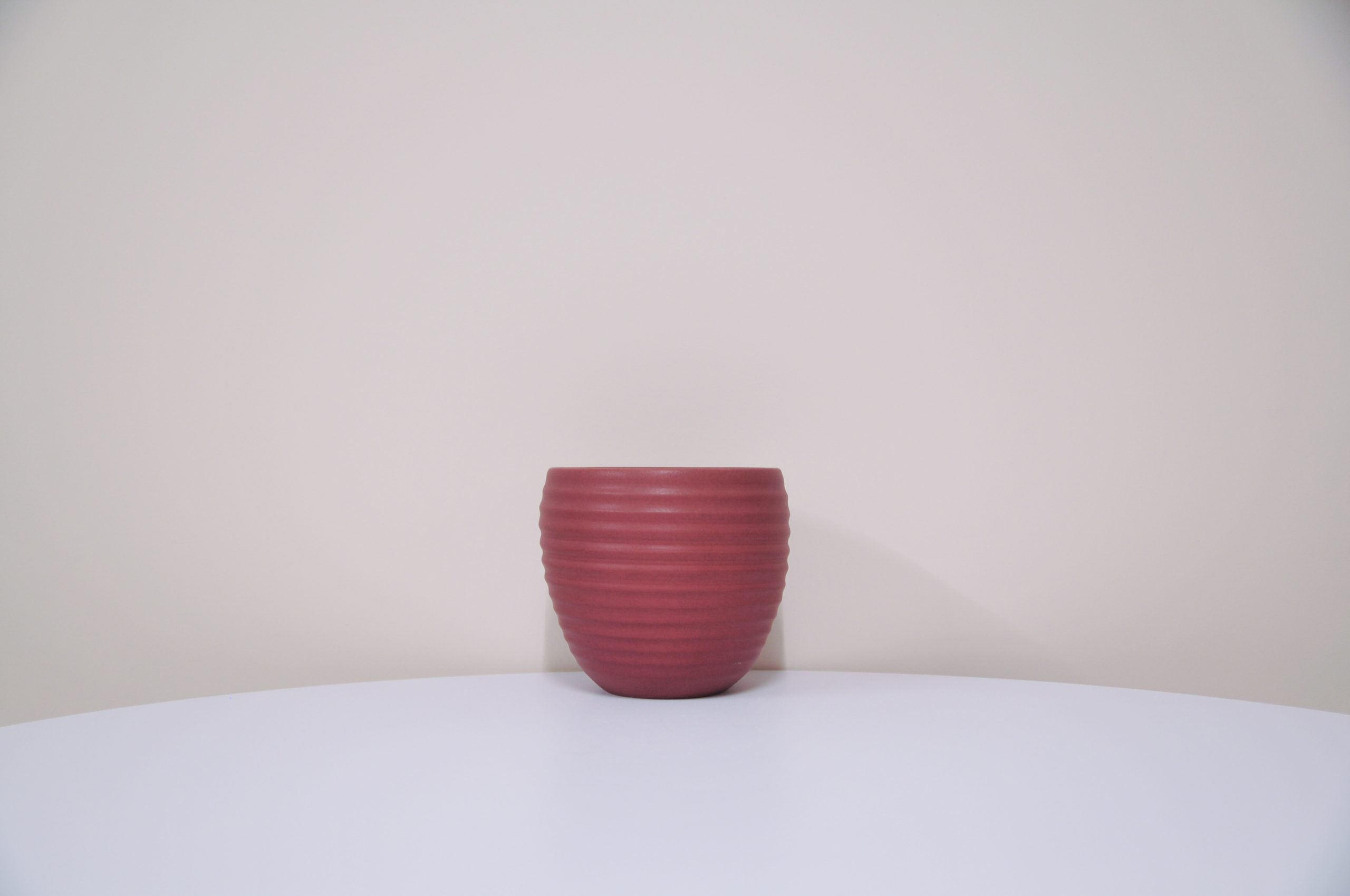 Brown bowl with a green and blue design