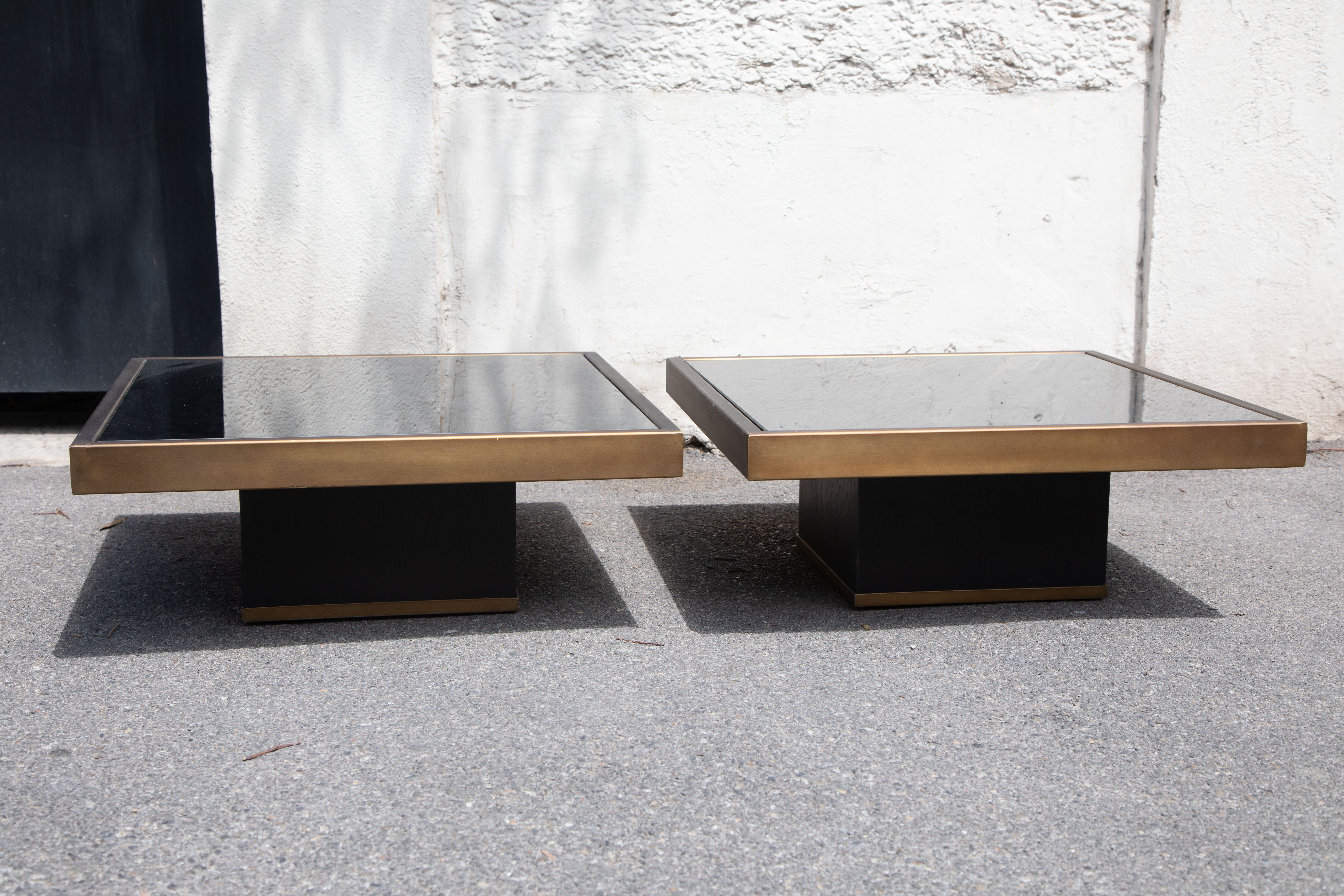 Pair of coffee tables brass black glass