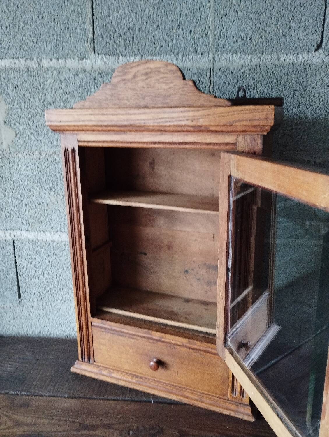 Old glass wall shelf with drawer door