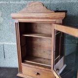 Old glass wall shelf with drawer door