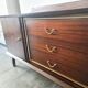 Dark wood sideboard with brass finishes and compass feet