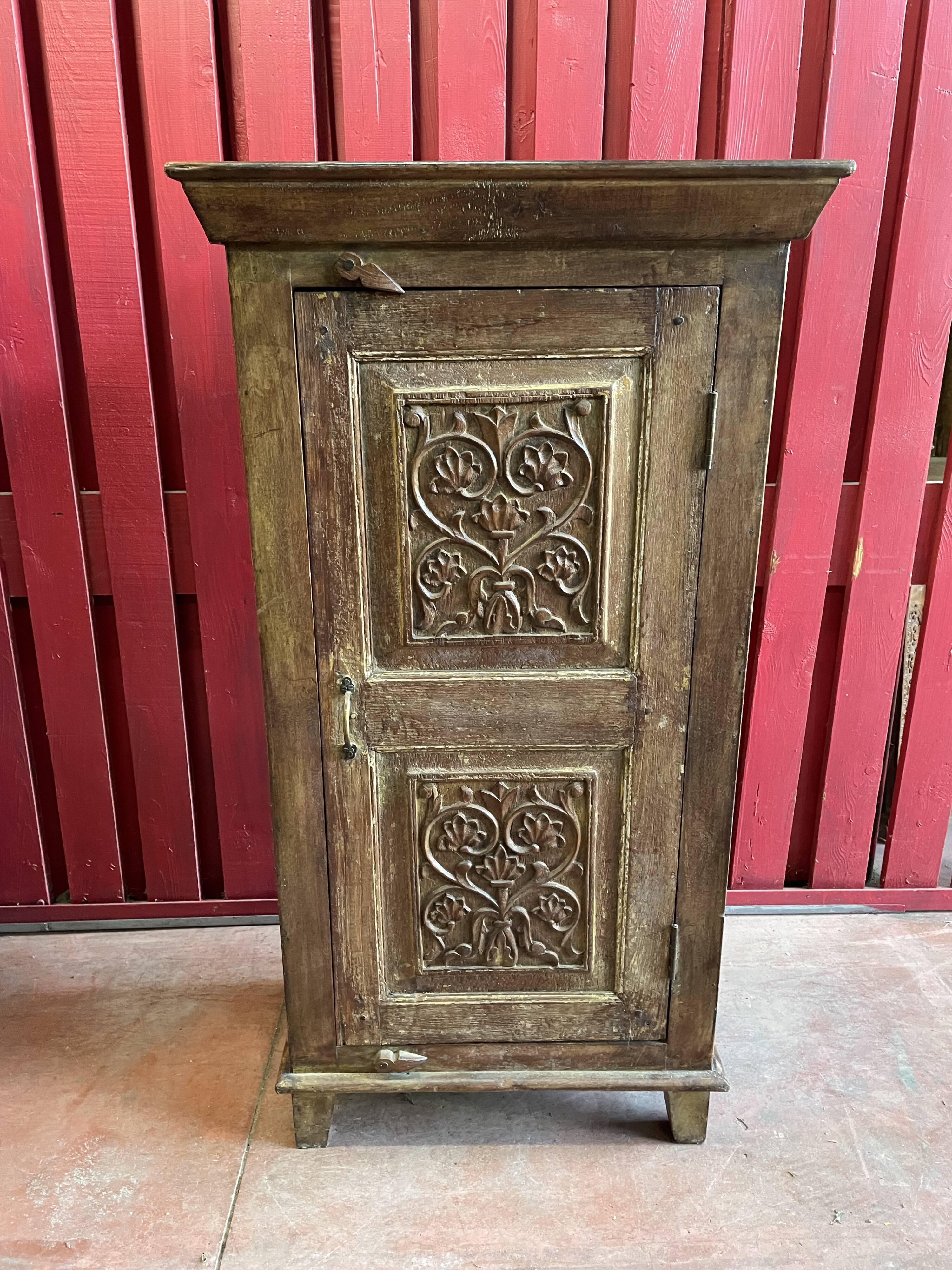 India. Bonnetière with a teak door finely carved by hand.