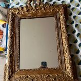 Golden trumeau mirror for fireplace, late 19th century, with sculpted pediment.