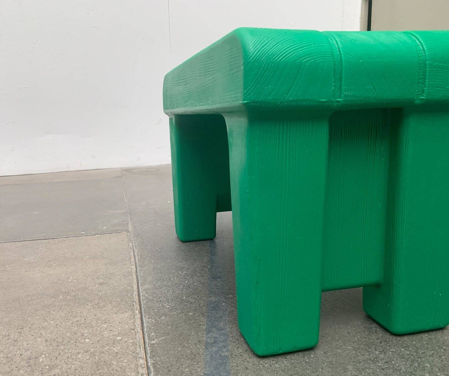 Postmodern plastic stool with a wood effect.