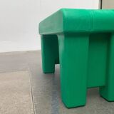 Postmodern plastic stool with a wood effect.