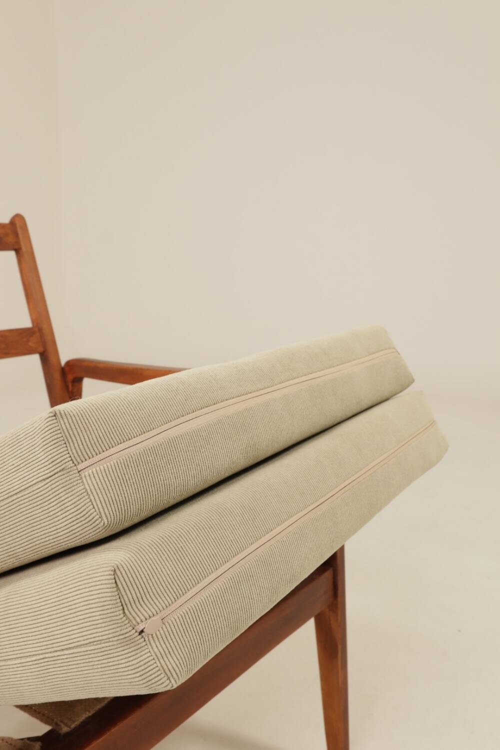 Vintage armchair in olive corduroy with a wooden frame.