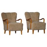 Pair of Mid Century Modern Swedish lounge chairs in birch and lamb's wool, 1960s.