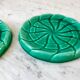 Duo of green slip bottle coasters signed marjac bauzil 50s