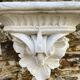 Antique wall console in patinated white plaster.