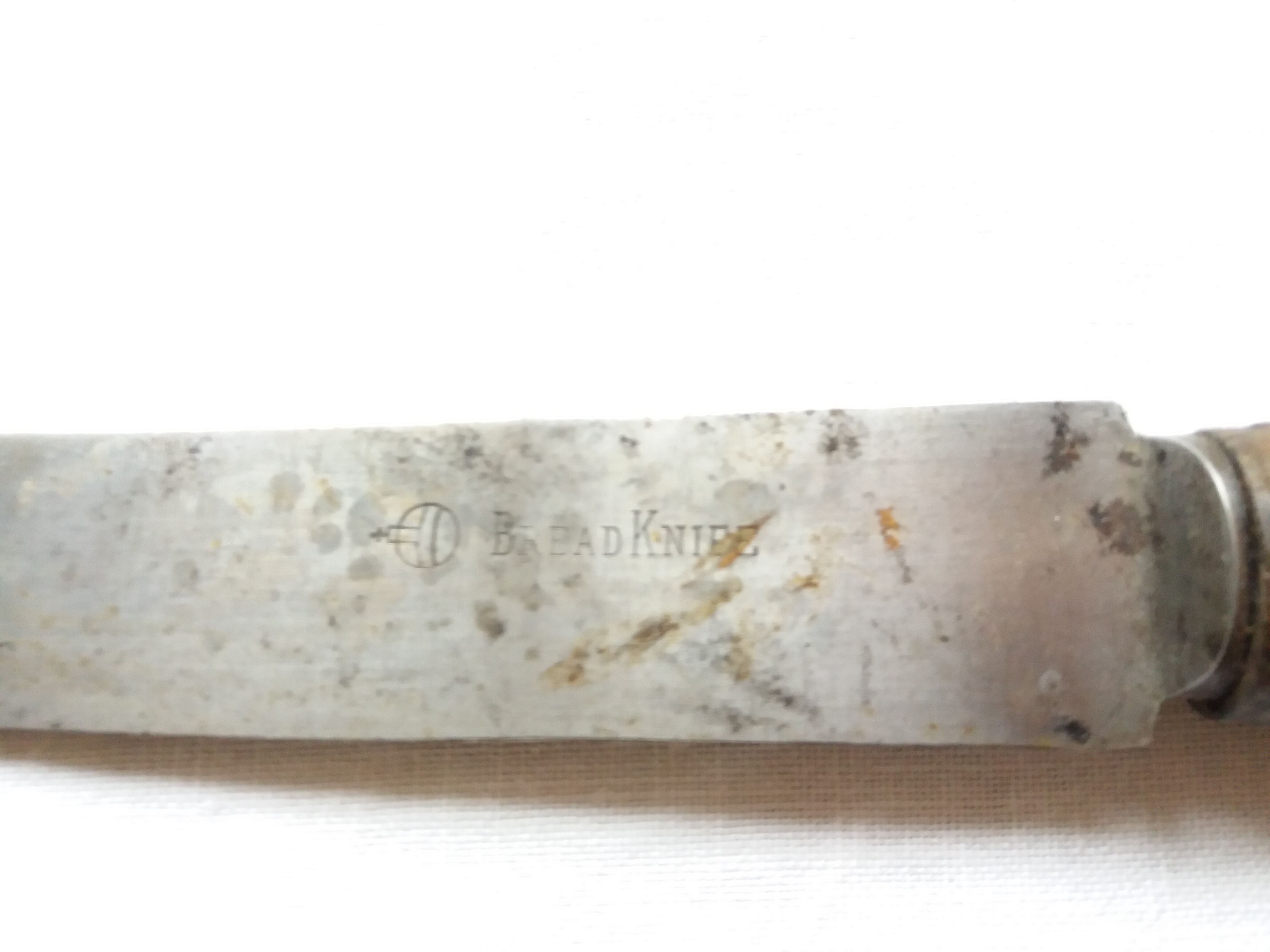 Old bread knife with a carved wooden handle