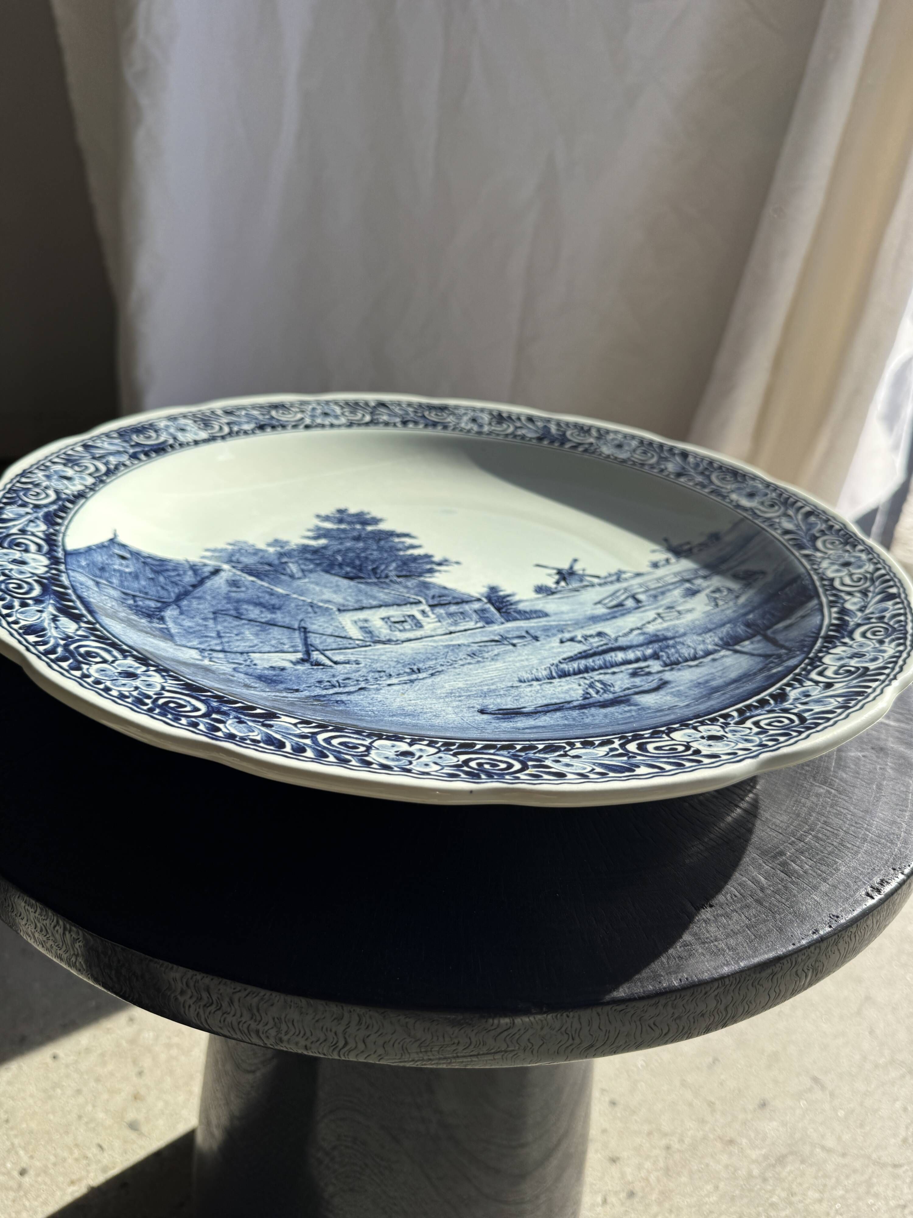 Vintage hollow circular plate in blue and white Boch pottery.