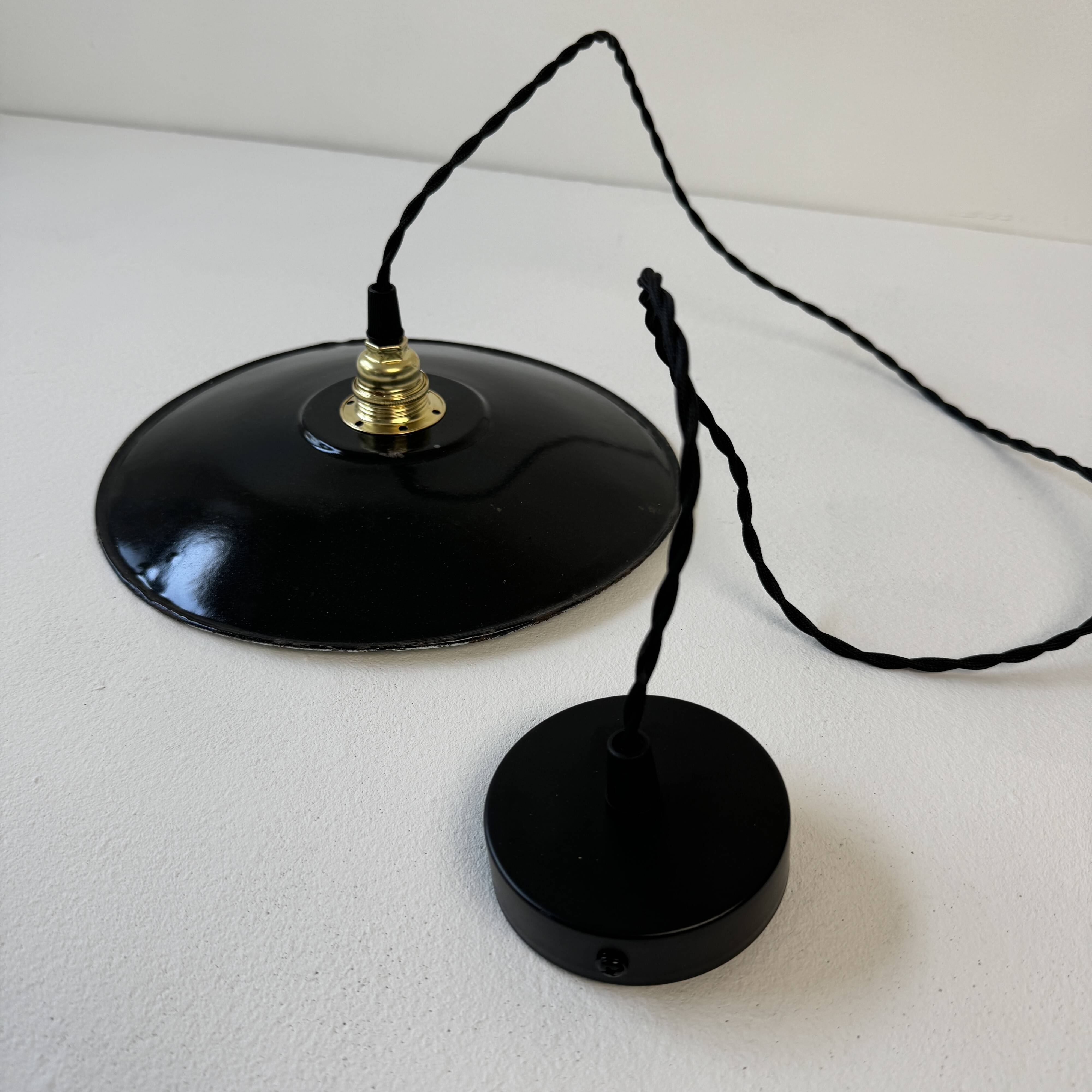 Pair of old industrial black enamelled pendant lights