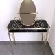 Brass hairdresser, glass and black plastic with its fluffy stool.