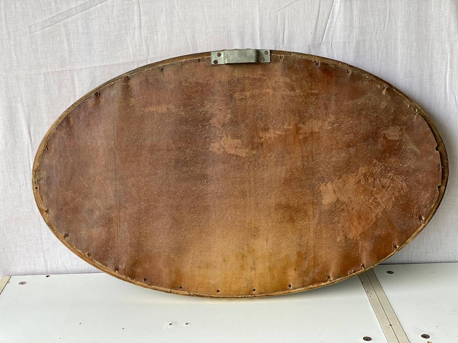 Vintage carved and gilded oval wall mirror