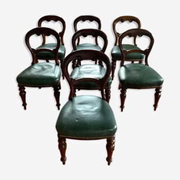 Set of seven Napoleon III chairs in solid walnut seated in leather.