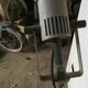 Industrial lamp on wrought iron tripod feet