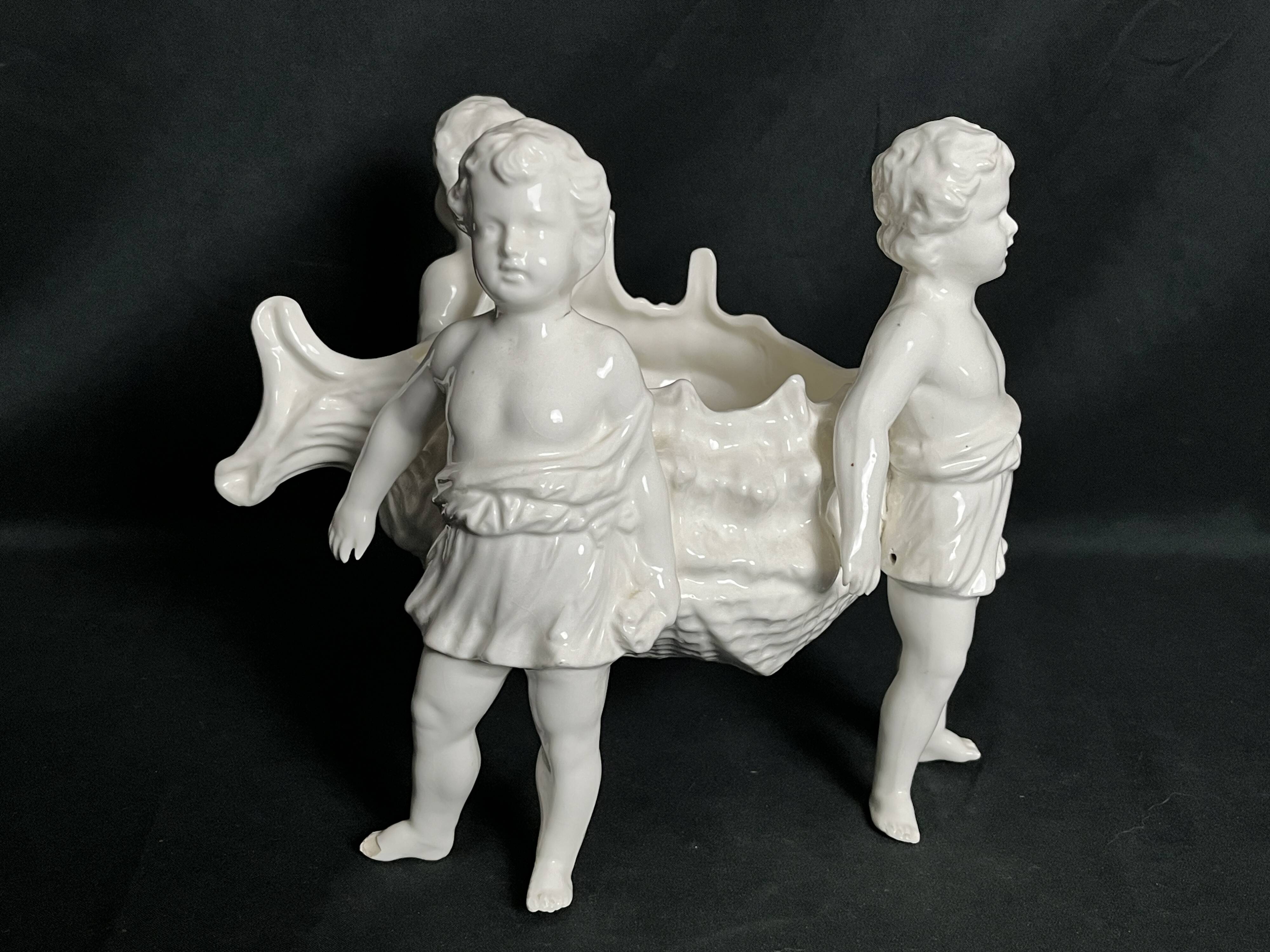 Porcelain, centerpiece with candle holder decorated with putti, 20th century