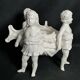 Porcelain, centerpiece with candle holder decorated with putti, 20th century